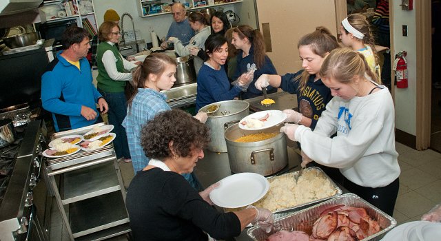 Kitchen volunteers at Saint Colman’s Church dinner for the needy