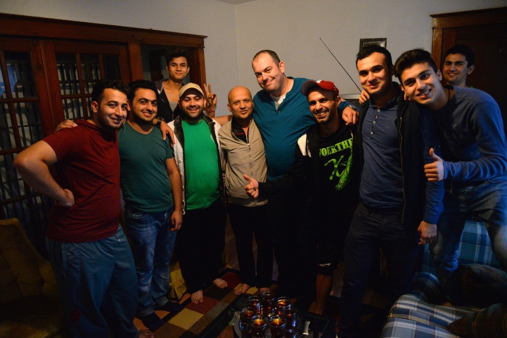 Dzemal Bijedic, center in the blue shirt, poses with Syrian refugees recently resettled in St. Louis.